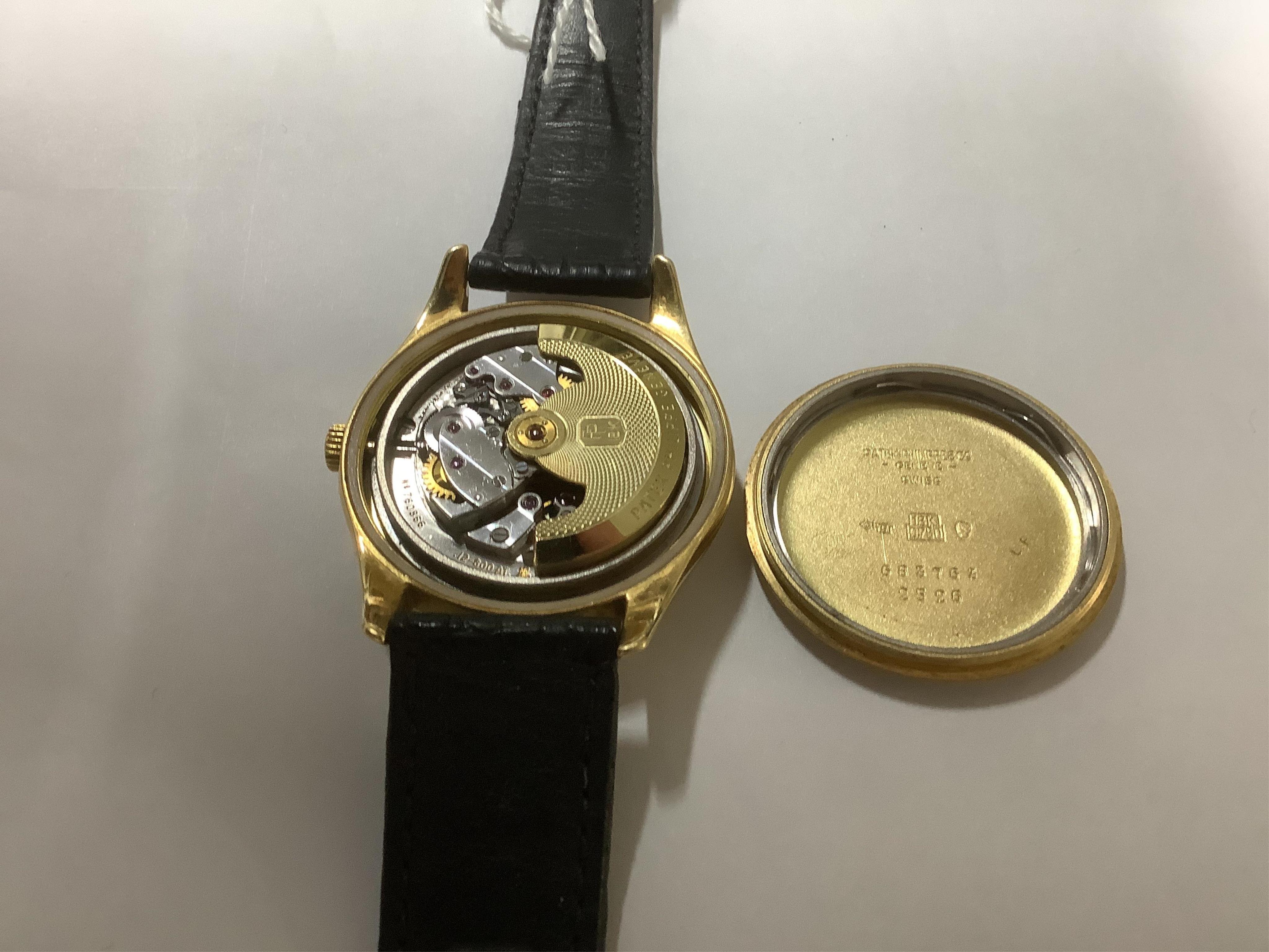 A gentleman's fine 18ct gold Patek Philippe Calatrava automatic wrist watch, model number 2526, on a Patek Philippe black leather strap with a Patek Philippe 18ct gold buckle